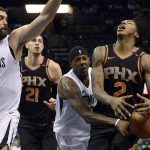 Phoenix Suns guard Elfrid Payton (2) drives against Memphis Grizzlies guard Mario Chalmers, second from right, as Grizzlies center Marc Gasol (33) and Suns center Alex Len (21) move for position in the second half of an NBA basketball game Wednesday, Feb. 28, 2018, in Memphis, Tenn. (AP Photo/Brandon Dill)