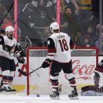 Los Angeles Kings celebrate at left as Arizona Coyotes goalie Scott Wedgewood (31) and center Christian Dvorak (18) react to a Kings goal during the third period of an NHL hockey game in Los Angeles Saturday, Feb. 3, 2018. The Kings won 6-0. (AP Photo/Reed Saxon)