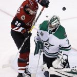 Arizona Coyotes right wing Christian Fischer (36) redirects the puck over the head of Dallas Stars goaltender Kari Lehtonen, right, during the third period of an NHL hockey game Thursday, Feb. 1, 2018, in Glendale, Ariz. The Stars defeated the Coyotes 4-1. (AP Photo/Ross D. Franklin)