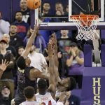 Washington's Noah Dickerson shoots over Arizona's Deandre Ayton, right, and Emmanuel Akot during the second half of an NCAA college basketball game Saturday, Feb. 3, 2018, in Seattle. Washington won 78-75 with Dickerson leading Washington with 25 points. (AP Photo/John Froschauer)