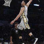 Cleveland Cavaliers' Larry Nance Jr. dunks as his fathe, Larry Nance, watches during the NBA basketball All-Star weekend slam dunk contest Saturday, Feb. 17, 2018, in Los Angeles. (AP Photo/Chris Pizzello)