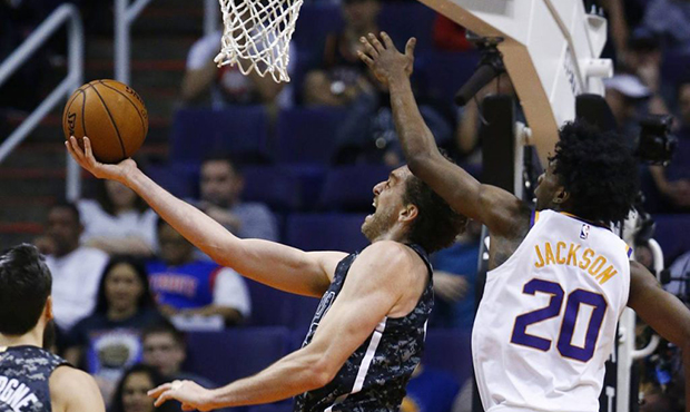 San Antonio Spurs center Pau Gasol, left, beats Phoenix Suns forward Josh Jackson (20) to the baske...