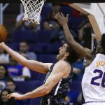 San Antonio Spurs center Pau Gasol, left, beats Phoenix Suns forward Josh Jackson (20) to the basket during the second half of an NBA basketball game Wednesday, Feb. 7, 2018, in Phoenix. The Spurs defeated the Suns 129-81. (AP Photo/Ross D. Franklin)