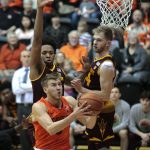 Oregon State's Tres Tinkle, front, drives to the basket past Arizona State's Kimani Lawrence, rear left, and Kodi Justice, rear right, in the first half of an NCAA college basketball game in Corvallis, Ore., Saturday, Feb. 24, 2018. (AP Photo/Timothy J. Gonzalez)