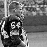 FILE - In this Nov. 24, 1963, file photo, Green Bay Packers offensive guard Jerry Kramer and coach Vince Lombardi watch the Packers' defense against the San Francisco 49ers in an NFL football game in Milwaukee. Kramer was elected to the Pro Football Hall of Fame on Saturday, Feb. 3, 2018. (AP Photo/File)