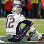 New England Patriots' Tom Brady sits on the field after the NFL Super Bowl 52 football game against the Philadelphia Eagles Sunday, Feb. 4, 2018, in Minneapolis. The Eagles won 41-33. (AP Photo/Charlie Neibergall)