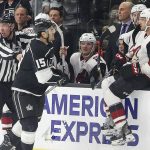 Los Angeles Kings center Brad Richardson, left, and Arizona Coyotes left winger Andy Andreoff (15, sitting on the board) have words next to the Coyotes' bench during the third period of an NHL hockey game in Los Angeles Saturday, Feb. 3, 2018. The Kings won 6-0. (AP Photo/Reed Saxon)