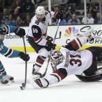Arizona Coyotes goaltender Scott Wedgewood (31) reaches for the puck in front of San Jose Sharks right wing Melker Karlsson (68), from Sweden, during the second period of an NHL hockey game in San Jose, Calif., Tuesday, Feb. 13, 2018. (AP Photo/Jeff Chiu)