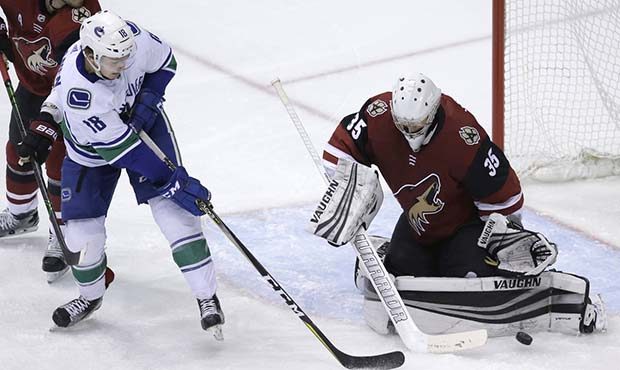 Arizona Coyotes goaltender Darcy Kuemper (35) makes the save on Vancouver Canucks right wing Jake V...