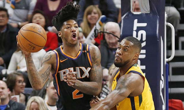 Phoenix Suns guard Elfrid Payton (2) passes the ball as Utah Jazz forward Derrick Favors, right, de...