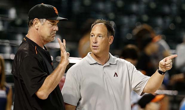 San Francisco Giants manager Bruce Bochy, left, and Luis Gonzalez talk before a baseball game, Satu...