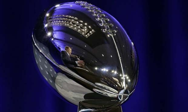 NFL Commissioner Roger Goodell is reflected in the Vince Lombardi Trophy as he speaks during a news...