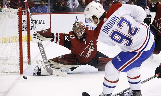 Arizona Coyotes goaltender Antti Raanta (32) makes a save on a shot by Montreal Canadiens center Jo...