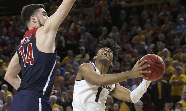 Arizona State guard Remy Martin (1) is fouled by Arizona center Dusan Ristic during the second half...