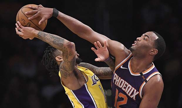 Phoenix Suns forward TJ Warren, right, blocks the shot of Los Angeles Lakers forward Brandon Ingram...