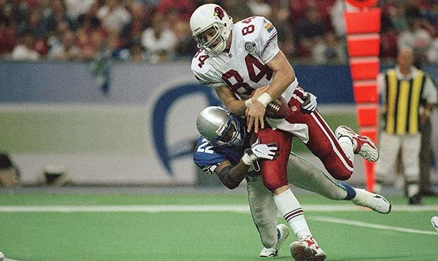 Arizona Cardinals’ Chris Gedney (84) takes in a pass while in the grasp of Seattle Seahawks’ Fr...