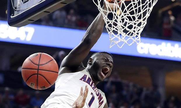 Arizona's Rawle Alkins dunks over Southern California's Elijah Stewart during the second half of an...