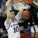 Kansas guard Sviatoslav Mykhailiuk (10) dunks during the second half of an NCAA college basketball game against West Virginia in the finals of the Big 12 men's tournament in Kansas City, Mo., Saturday, March 10, 2018. (AP Photo/Orlin Wagner)