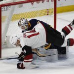 Arizona Coyotes forward Richard Panik (14) collides with Buffalo Sabres goalie Chad Johnson during the first period of an NHL hockey game Wednesday, March 21, 2018, in Buffalo, N.Y. (AP Photo/Jeffrey T. Barnes)