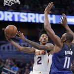 Phoenix Suns' Elfrid Payton (2) passes the ball as he is defended by Orlando Magic's Bismack Biyombo (11) during the second half of an NBA basketball game, Saturday, March 24, 2018, in Orlando, Fla. (AP Photo/John Raoux)