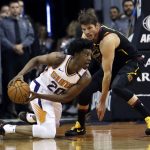 Phoenix Suns guard Josh Jackson (20) and Cleveland Cavaliers guard Kyle Korver battle for a loose ball in the first half of an NBA basketball game, Tuesday, March 13, 2018, in Phoenix. (AP Photo/Rick Scuteri)