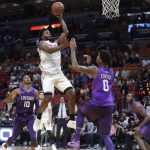 Miami Heat's Justise Winslow, center, drives as Phoenix Suns' Shaquille Harrison (10) and Marquese Chriss (0) defend during the second half of an NBA basketball game, Monday, March 5, 2018, in Miami. The Heat won 125-103. (AP Photo/Lynne Sladky)