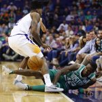 Boston Celtics guard Terry Rozier III (12) loses control of the ball as Phoenix Suns guard Elfrid Payton, left, defends during the first half of an NBA basketball game Monday, March 26, 2018, in Phoenix. (AP Photo/Ross D. Franklin)