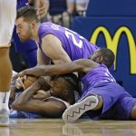 Oklahoma City Thunder forward Jerami Grant, bottom, fights for the ball with Phoenix Suns forward Alec Peters, top, and guard Davon Reed during the second half of an NBA basketball game in Oklahoma City, Thursday, March 8, 2018. (AP Photo/Sue Ogrocki)
