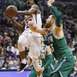 Phoenix Suns guard Josh Jackson, left, drives past Boston Celtics center Aron Baynes, right, during the second half of an NBA basketball game, Monday, March 26, 2018, in Phoenix. The Celtics defeated the Suns 102-94. (AP Photo/Ross D. Franklin)