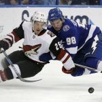 Arizona Coyotes center Nick Cousins (25) gets taken down by Tampa Bay Lightning defenseman Mikhail Sergachev (98) during the first period of an NHL hockey game Monday, March 26, 2018, in Tampa, Fla. (AP Photo/Chris O'Meara)