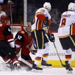 Arizona Coyotes goaltender Antti Raanta (32) gives up a goal to Calgary Flames' Dougie Hamilton as Flames right wing Chris Stewart (8), center Matt Stajan (18), and Coyotes defenseman Kevin Connauton (44) look on during the second period of an NHL hockey game, Monday, March 19, 2018, in Glendale, Ariz. (AP Photo/Ross D. Franklin)