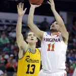 Virginia's Ty Jerome (11) shoots past UMBC's Joe Sherburne (13) during the second half of a first-round game in the NCAA men's college basketball tournament in Charlotte, N.C., Friday, March 16, 2018. (AP Photo/Bob Leverone)