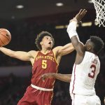 Iowa State's Lindell Wigginton, left, goes up to shoot over Ou's Khadeem Lattin in the first half of an NCAA college basketball game Friday, March 2, 2018, in Norman, Okla. (AP Photo/Kyle Phillips)
