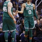 Boston Celtics forward Jayson Tatum (0) slaps hands with center Aron Baynes (46) after Tatum scored against the Phoenix Suns during the second half of an NBA basketball game, Monday, March 26, 2018, in Phoenix. The Celtics defeated the Suns 102-94. (AP Photo/Ross D. Franklin)