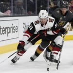Arizona Coyotes right wing Christian Fischer (36) skates around Vegas Golden Knights defenseman Jon Merrill during the first period of an NHL hockey game, Wednesday, March 28, 2018, in Las Vegas. (AP Photo/John Locher)