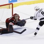 Los Angeles Kings left wing Adrian Kempe (9) scores against Arizona Coyotes goaltender Adin Hill, left, during a shootout of an NHL hockey game Tuesday, March 13, 2018, in Glendale, Ariz. The Coyotes defeated the Kings 4-3. (AP Photo/Ross D. Franklin)