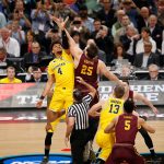Michigan's Isaiah Livers (4) and Loyola-Chicago's Cameron Krutwig (25) battle for the ball at the tip off during the first half in the semifinals of the Final Four NCAA college basketball tournament, Saturday, March 31, 2018, in San Antonio. (AP Photo/Brynn Anderson)