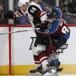 Arizona Coyotes defenseman Jason Demers, left, fights off Colorado Avalanche left wing Matt Nieto as they battle for control of the puck in the second period of an NHL hockey game Saturday, March 10, 2018, in Denver. (AP Photo/David Zalubowski)