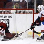 Arizona Coyotes goaltender Antti Raanta (32) jumps out to cover the puck as Ottawa Senators center Jean-Gabriel Pageau (44) arrives too late to get a stick on it during the second period of an NHL hockey game Saturday, March 3, 2018, in Glendale, Ariz. (AP Photo/Ross D. Franklin)