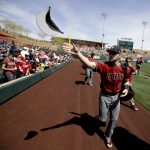 Arizona Diamondbacks shortstop Chris Owings tosses out hats before a spring baseball game against the Colorado Rockies in Scottsdale, Ariz., Sunday, March 25, 2018. (AP Photo/Chris Carlson)