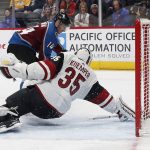 Colorado Avalanche left wing Blake Comeau, back, scores a goal past Arizona Coyotes goaltender Darcy Kuemper in the first period of an NHL hockey game Saturday, March 10, 2018, in Denver. (AP Photo/David Zalubowski)