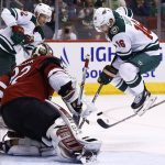 Minnesota Wild left wing Jason Zucker (16) jumps over a stick as he tries to redirect a shot by Wild center Eric Staal (12) as Arizona Coyotes goaltender Antti Raanta (32) protects the goal during the third period of an NHL hockey game Saturday, March 17, 2018, in Glendale, Ariz. The Wild defeated the Coyotes 3-1. (AP Photo/Ross D. Franklin)