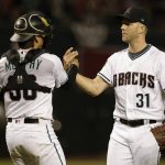 Arizona Diamondbacks relief pitcher Brad Boxberger, right, and John Ryan Murphy, left, celebrate after defeating the Colorado Rockies 9-8 during a baseball game, Friday, March 30, 2018, in Phoenix. (AP Photo/Rick Scuteri)