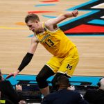 Michigan's Moritz Wagner (13) jumps over the broadcast table during the second half in the semifinals of the Final Four NCAA college basketball tournament against Loyola-Chicago, Saturday, March 31, 2018, in San Antonio. (AP Photo/Brynn Anderson)
