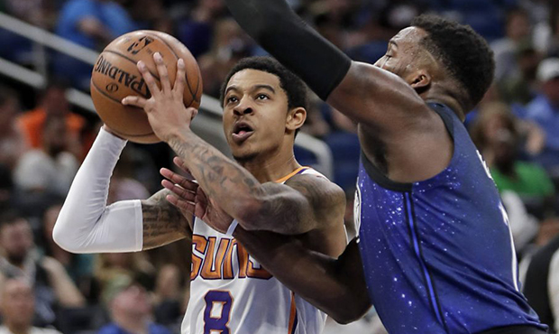 Phoenix Suns' Tyler Ulis (8) shoots against Orlando Magic's Shelvin Mack, right, during the second ...
