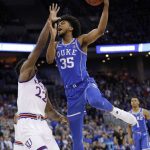 Duke's Marvin Bagley III (35) shoots over Kansas' Silvio De Sousa (22) during the first half of a regional final game in the NCAA men's college basketball tournament Sunday, March 25, 2018, in Omaha, Neb. (AP Photo/Charlie Neibergall)