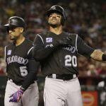 Colorado Rockies left fielder Ian Desmond (20) reacts after hitting a two run home-run in the second inning during a baseball game against the Arizona Diamondbacks, Friday, March 30, 2018, in Phoenix. (AP Photo/Rick Scuteri)