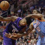 Phoenix Suns forward Marquese Chriss (0) is fouled by Los Angeles Clippers guard Tyrone Wallace (12) during the second half of an NBA basketball game Wednesday, March 28, 2018, in Phoenix. (AP Photo/Matt York)
