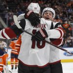 Arizona Coyotes' Christian Dvorak (18) and Max Domi (16) celebrate a goal against the Edmonton Oilers during the third period of an NHL game, Monday, March 5, 2018, in Edmonton, Alberta. Edmonton won 4-3 in overtime. (Jason Franson/The Canadian Press via AP)