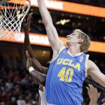 UCLA's Thomas Welsh reaches for a rebound during the first half of the team's NCAA college basketball game against Arizona in the semifinals of the Pac-12 men's tournament Friday, March 9, 2018, in Las Vegas. Arizona won 78-67 in overtime. (AP Photo/Isaac Brekken)
